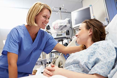 nursing student talking to female patient on placement